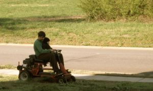 Nash enjoys mowing the grass with dad